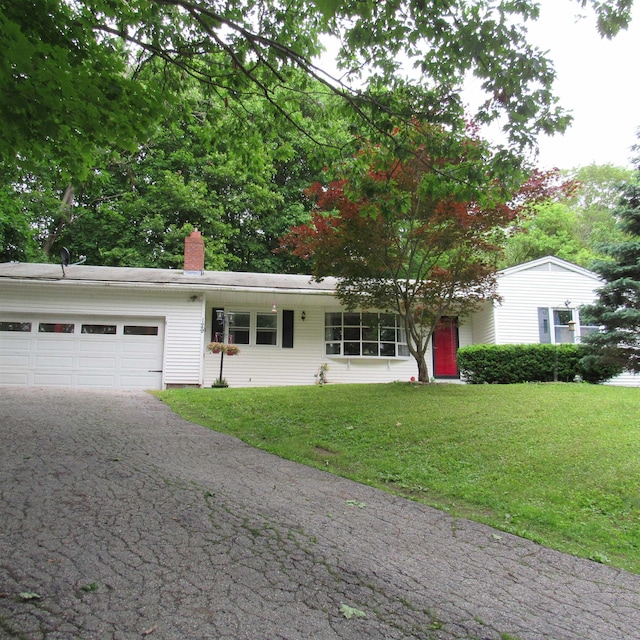 129 Chestnut St, Claremont, NH 03743 - single story home featuring an attached garage, driveway, a front lawn, and a chimney