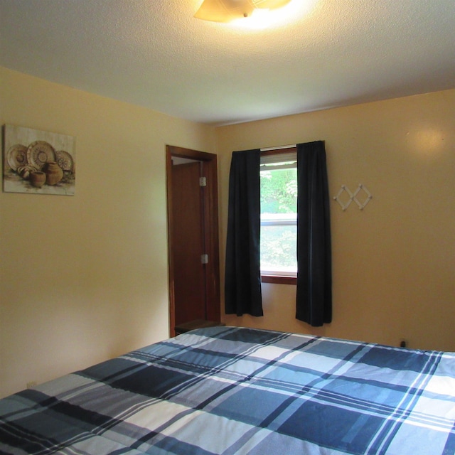 129 Chestnut St, Claremont, NH 03743 - unfurnished bedroom featuring a textured ceiling