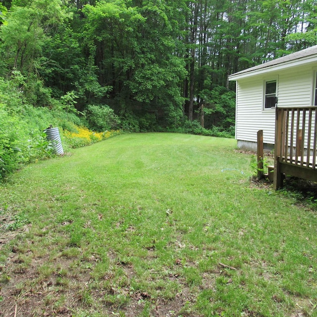 129 Chestnut St, Claremont, NH 03743 - view of green lawn with a deck