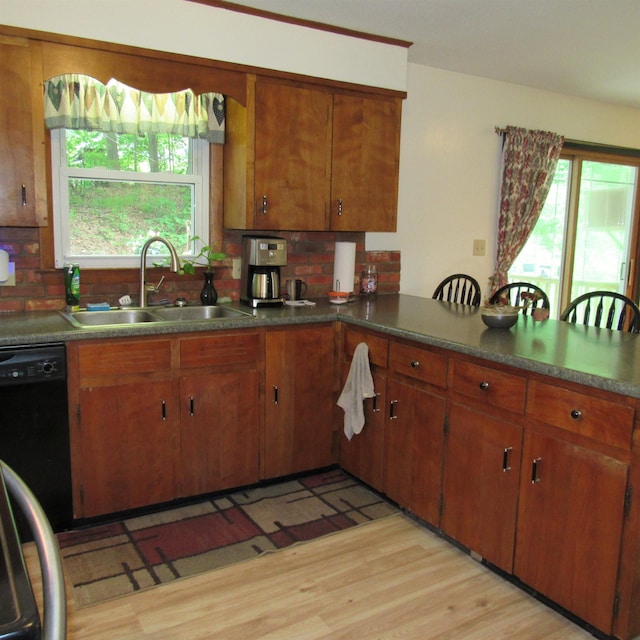 129 Chestnut St, Claremont, NH 03743 - kitchen with backsplash, plenty of natural light, and brown cabinetry