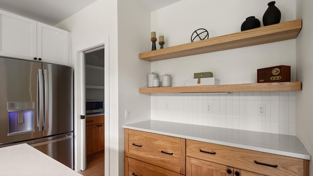3148 Mountain Rd Unit B, Stowe, VT 05672 - kitchen with appliances with stainless steel finishes, open shelves, tasteful backsplash, light countertops, and white cabinets