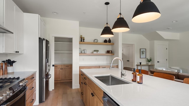 3148 Mountain Rd Unit B, Stowe, VT 05672 - kitchen with stainless steel appliances, light wood-style flooring, light countertops, open shelves, and decorative light fixtures