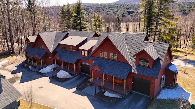 3148 Mountain Rd Unit B, Stowe, VT 05672 - aerial view of property and surrounding area featuring a heavily wooded area and mountains