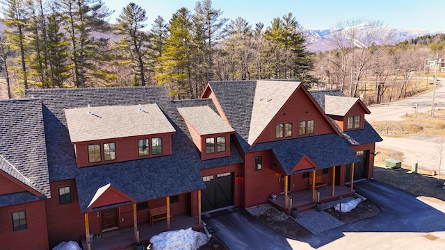 3148 Mountain Rd Unit B, Stowe, VT 05672 - view of front of house with a porch, roof with shingles, an attached garage, and a mountain view