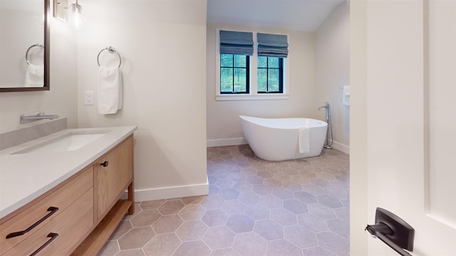 3148 Mountain Rd Unit B, Stowe, VT 05672 - bathroom featuring vanity, a freestanding tub, and tile patterned flooring
