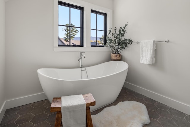 3148 Mountain Rd Unit B, Stowe, VT 05672 - bathroom featuring a freestanding bath and tile patterned floors