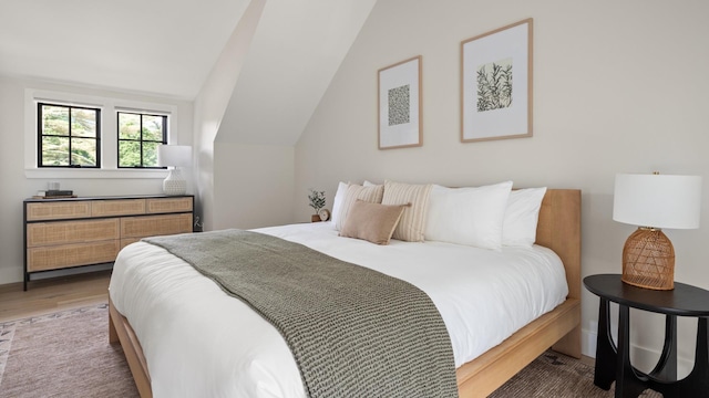 3148 Mountain Rd Unit B, Stowe, VT 05672 - bedroom featuring wood finished floors and vaulted ceiling