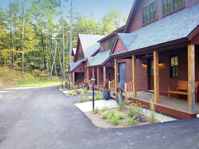3148 Mountain Rd Unit B, Stowe, VT 05672 - view of side of property featuring a porch and a shingled roof