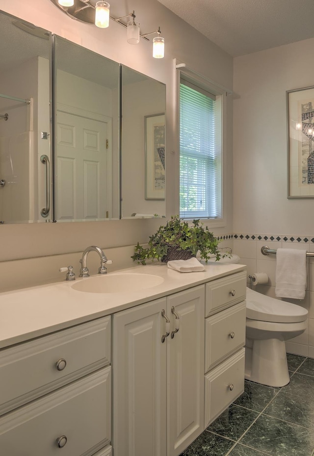 53 Summit Ridge Dr, Keene, NH 03431 - bathroom featuring vanity, a shower, and tile walls