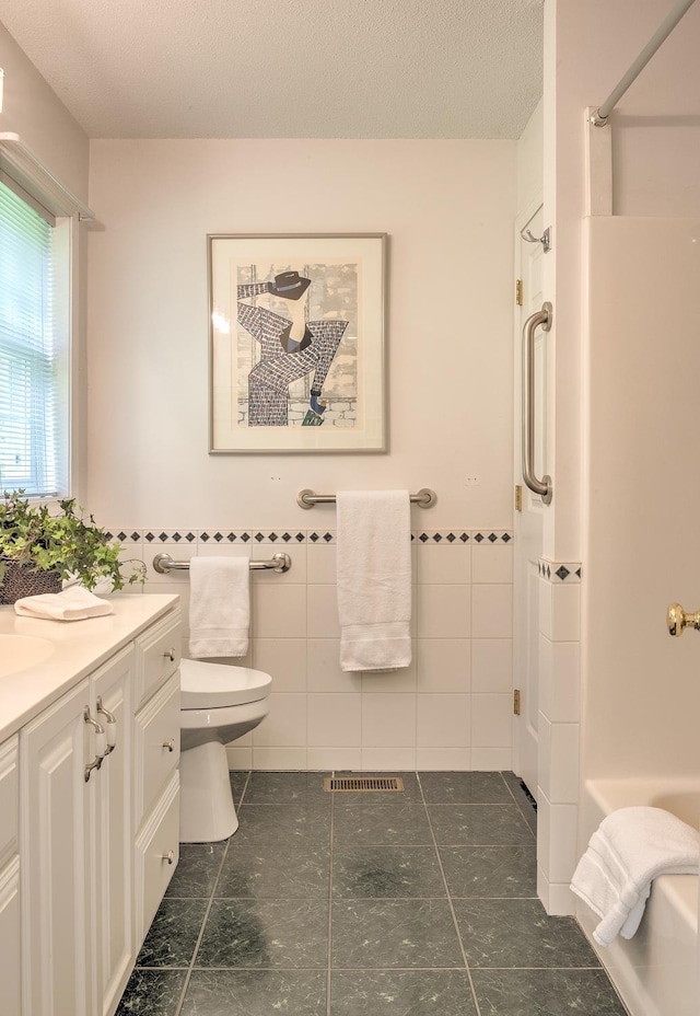 53 Summit Ridge Dr, Keene, NH 03431 - bathroom featuring tile walls, vanity, and a wainscoted wall