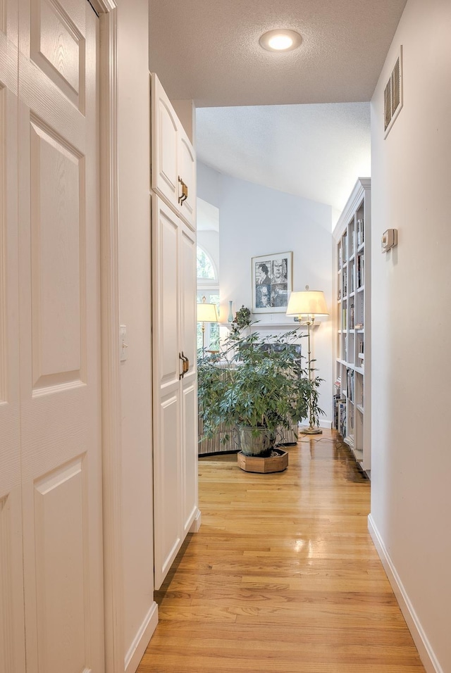 53 Summit Ridge Dr, Keene, NH 03431 - hallway featuring vaulted ceiling, light wood-type flooring, recessed lighting, and a textured ceiling