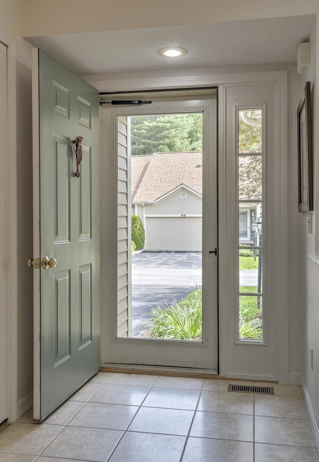 53 Summit Ridge Dr, Keene, NH 03431 - doorway featuring light tile patterned flooring, a textured ceiling, and healthy amount of natural light