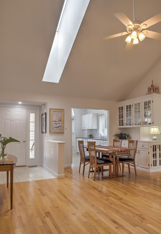 53 Summit Ridge Dr, Keene, NH 03431 - dining room featuring a skylight, high vaulted ceiling, light wood-type flooring, and a ceiling fan