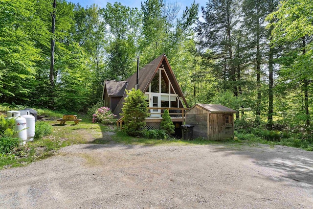 11 Island Dr, Madison, NH 03849 - view of front of house featuring a shed, a wooden deck, and a forest view
