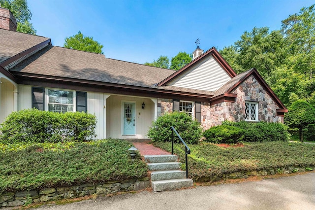 5 Melendy Holw, Amherst, NH 03031 - view of front of home with a chimney, stone siding, and a shingled roof