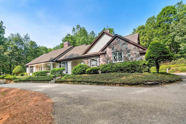 5 Melendy Holw, Amherst, NH 03031 - view of front of house featuring stone siding, a chimney, and driveway