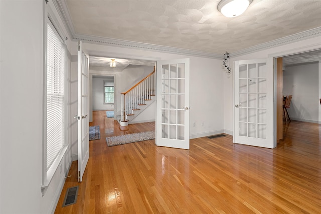 8 Aulson Rd, Salem, NH 03079 - spare room with french doors, light wood-style floors, stairway, and crown molding