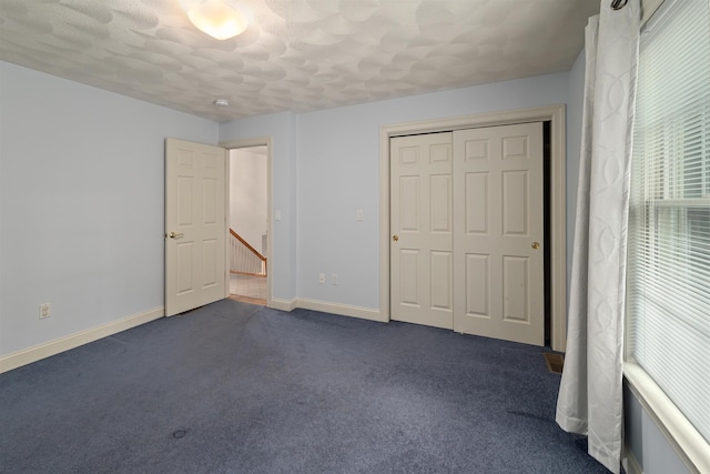 8 Aulson Rd, Salem, NH 03079 - unfurnished bedroom with dark carpet, a closet, and a textured ceiling