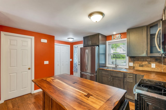 31 Bluffs Dr, Concord, NH 03303 - kitchen with appliances with stainless steel finishes, butcher block countertops, tasteful backsplash, and light wood-style flooring