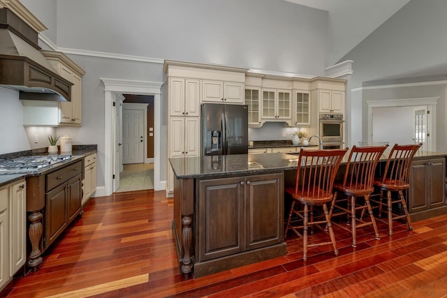 85 Blueberry Hill Rd, Meredith, NH 03253 - kitchen with appliances with stainless steel finishes, custom exhaust hood, cream cabinets, dark wood-style floors, and high vaulted ceiling