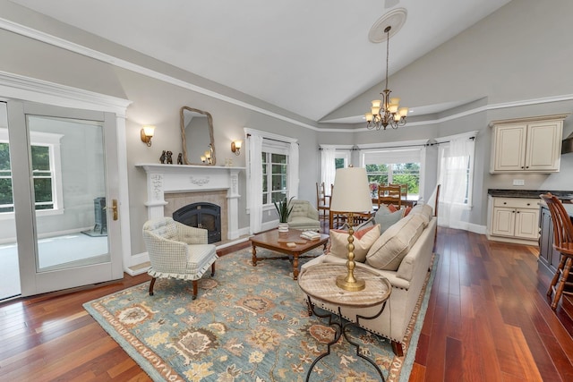 85 Blueberry Hill Rd, Meredith, NH 03253 - living room featuring a chandelier, lofted ceiling, a glass covered fireplace, and dark wood finished floors