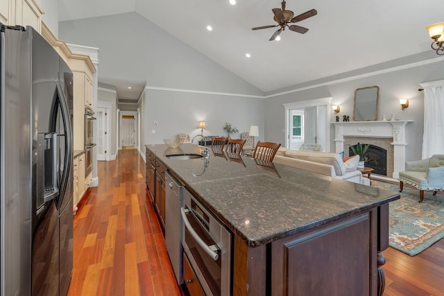 85 Blueberry Hill Rd, Meredith, NH 03253 - kitchen with stainless steel appliances, high vaulted ceiling, a large island, a ceiling fan, and a fireplace