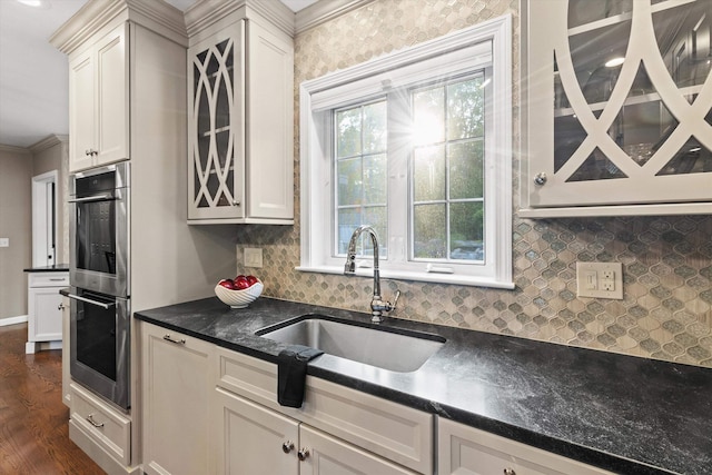 104 Windsor Dr, Auburn, NH 03032 - kitchen with double oven, dark countertops, tasteful backsplash, dark wood-style flooring, and white cabinetry