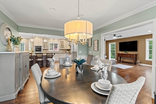 104 Windsor Dr, Auburn, NH 03032 - dining room with a chandelier, wood finished floors, ceiling fan, and crown molding