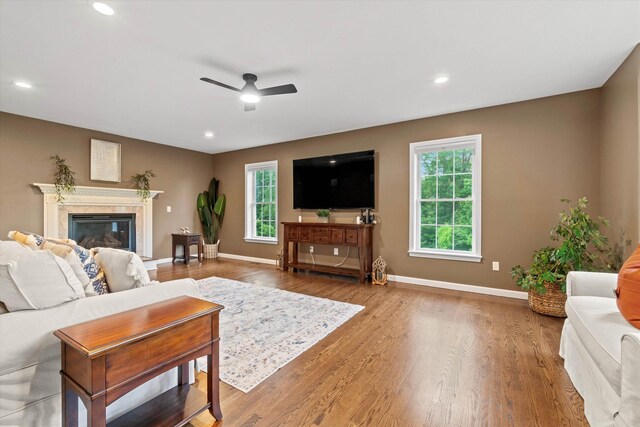 104 Windsor Dr, Auburn, NH 03032 - living area featuring a ceiling fan, wood finished floors, a high end fireplace, and recessed lighting