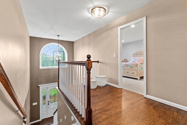 104 Windsor Dr, Auburn, NH 03032 - stairway with wood finished floors and a chandelier