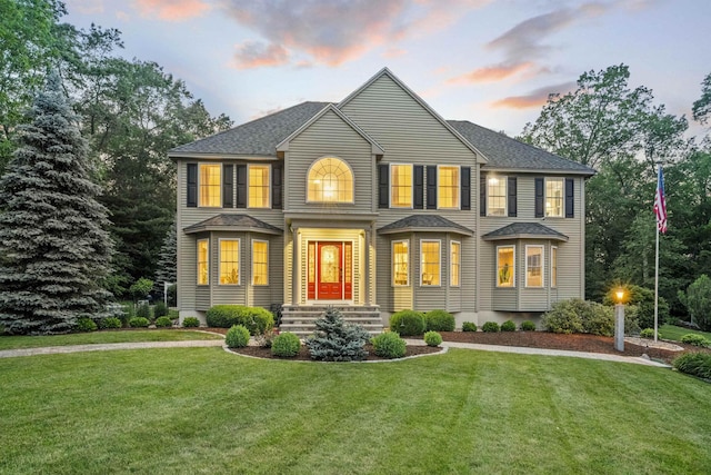 104 Windsor Dr, Auburn, NH 03032 - view of front facade featuring a front lawn and a shingled roof