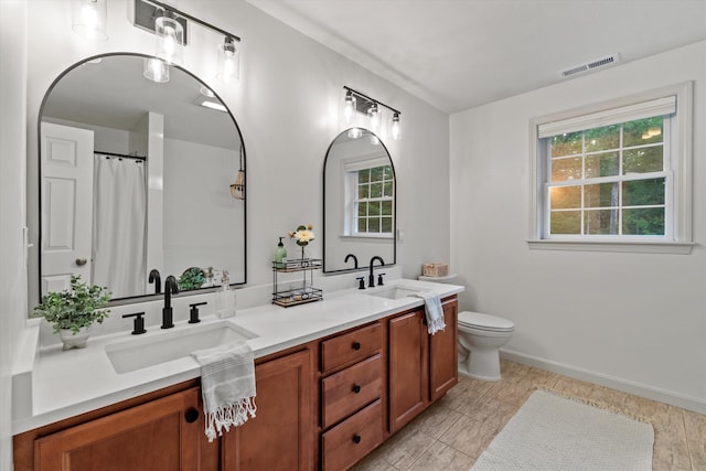 104 Windsor Dr, Auburn, NH 03032 - bathroom with double vanity and a shower with curtain