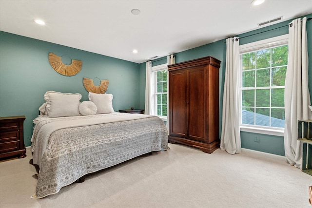104 Windsor Dr, Auburn, NH 03032 - bedroom with light carpet, multiple windows, and recessed lighting