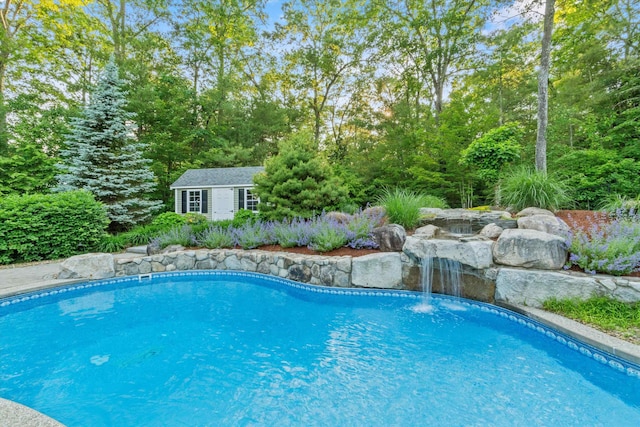 104 Windsor Dr, Auburn, NH 03032 - outdoor pool featuring an outdoor structure and a storage structure