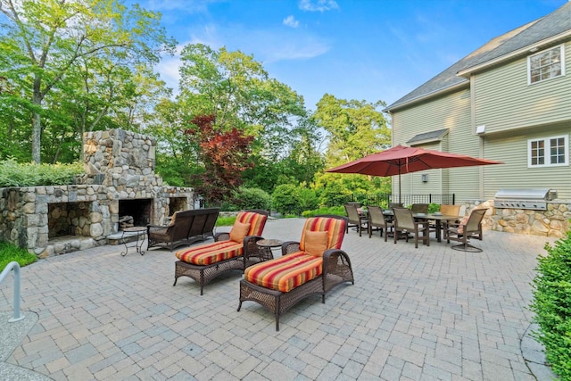 104 Windsor Dr, Auburn, NH 03032 - view of patio with area for grilling, outdoor dining space, and an outdoor stone fireplace
