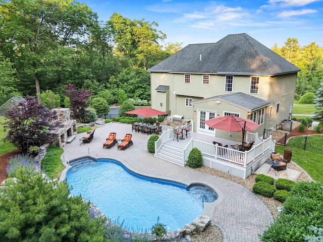 104 Windsor Dr, Auburn, NH 03032 - back of house featuring outdoor dining space, a deck, a fenced backyard, outdoor lounge area, and an outdoor pool