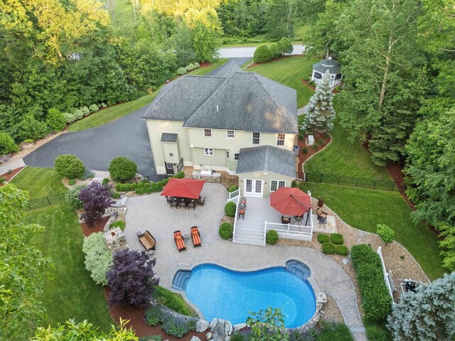 104 Windsor Dr, Auburn, NH 03032 - back of house with a fenced backyard, a wooden deck, an outdoor pool, and outdoor dining area