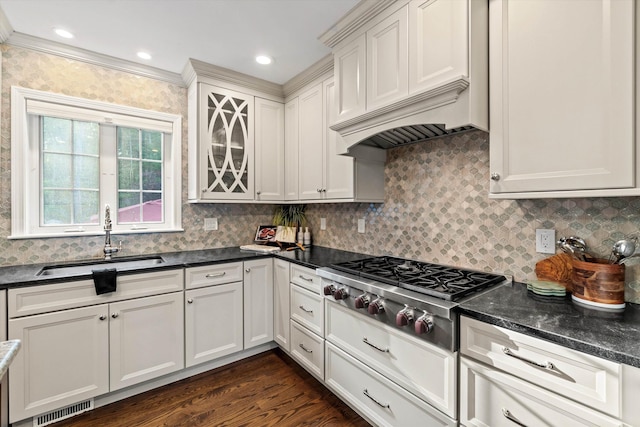 104 Windsor Dr, Auburn, NH 03032 - kitchen with stainless steel gas stovetop, tasteful backsplash, premium range hood, dark wood-type flooring, and ornamental molding