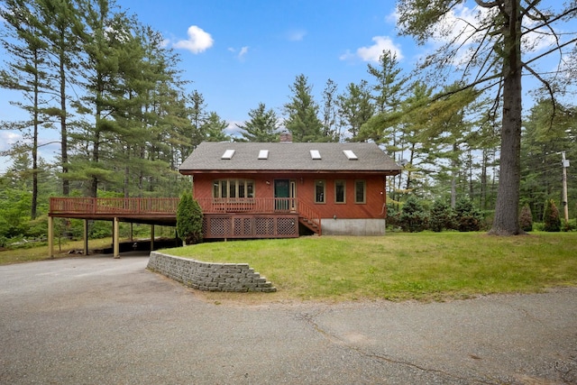 26 Old Mill Rd, Ossipee, NH 03890 - view of front of property with a wooden deck, a front yard, and a chimney