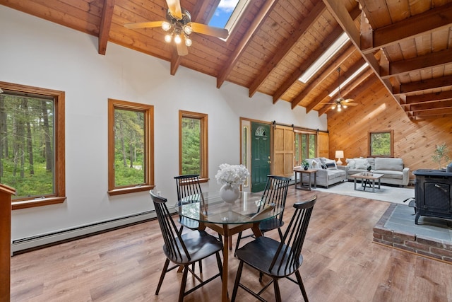 26 Old Mill Rd, Ossipee, NH 03890 - dining room featuring a baseboard heating unit, a ceiling fan, wood finished floors, a barn door, and a wooden ceiling with exposed beams