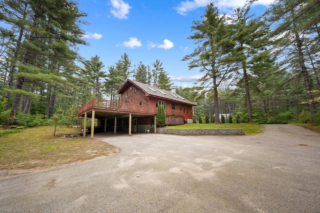 26 Old Mill Rd, Ossipee, NH 03890 - view of side of property with driveway, a deck, and a carport