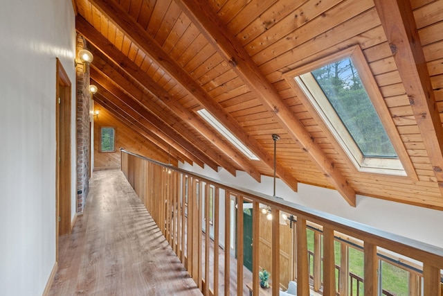 26 Old Mill Rd, Ossipee, NH 03890 - hall with a skylight, wood ceiling, plenty of natural light, and wooden walls