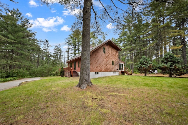 26 Old Mill Rd, Ossipee, NH 03890 - view of property exterior with a yard and a deck