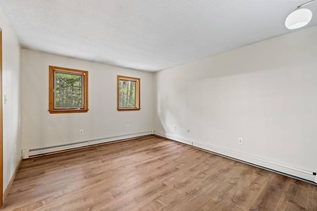 26 Old Mill Rd, Ossipee, NH 03890 - empty room featuring wood finished floors and a baseboard heating unit