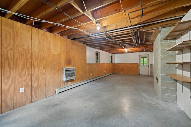 26 Old Mill Rd, Ossipee, NH 03890 - basement featuring baseboard heating, wooden walls, and heating unit
