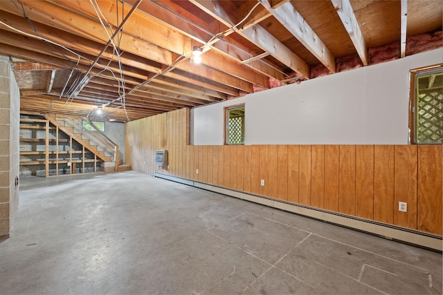 26 Old Mill Rd, Ossipee, NH 03890 - basement with a baseboard radiator, stairs, wooden walls, and a wainscoted wall
