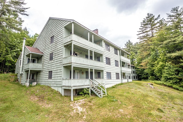 11E- Seasons Of Attitash Rd Unit E, Bartlett, NH 03812 - view of home's exterior with a balcony, a chimney, and a lawn