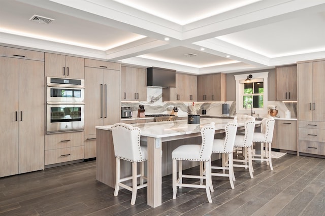 5 Michaels Way, Laconia, NH 03246 - kitchen featuring appliances with stainless steel finishes, a kitchen breakfast bar, light stone countertops, modern cabinets, and coffered ceiling