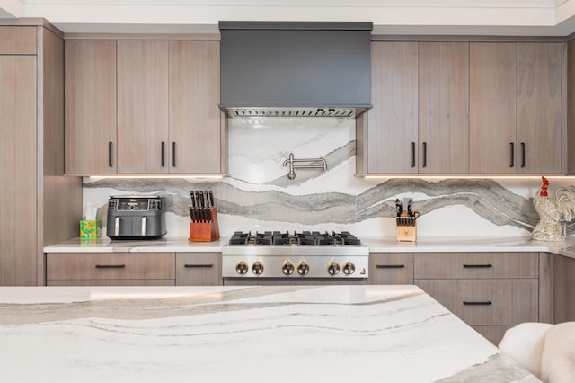 5 Michaels Way, Laconia, NH 03246 - kitchen with custom exhaust hood, modern cabinets, stainless steel gas stovetop, and light stone counters