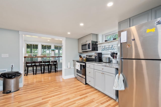 5 Michaels Way, Laconia, NH 03246 - kitchen featuring stainless steel appliances, recessed lighting, light wood-type flooring, and plenty of natural light